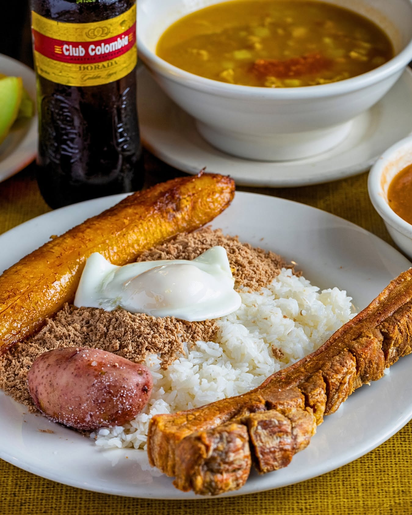 Bandeja paisa plate with chicharrón, rice, egg and sweet plantain