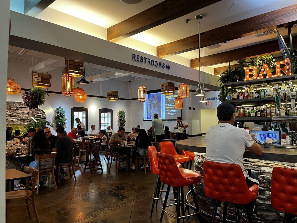 Busy Mondongo's dining room with guests seated beside the bar