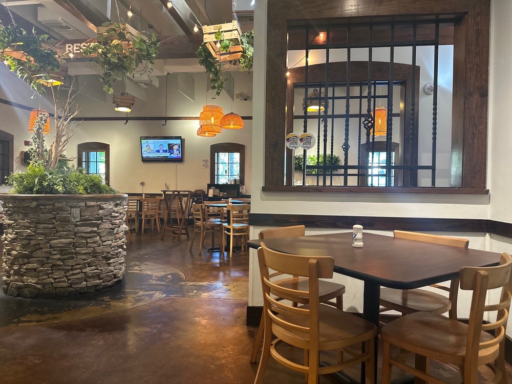 Mondongo's dining room with hanging plants and wooden tables