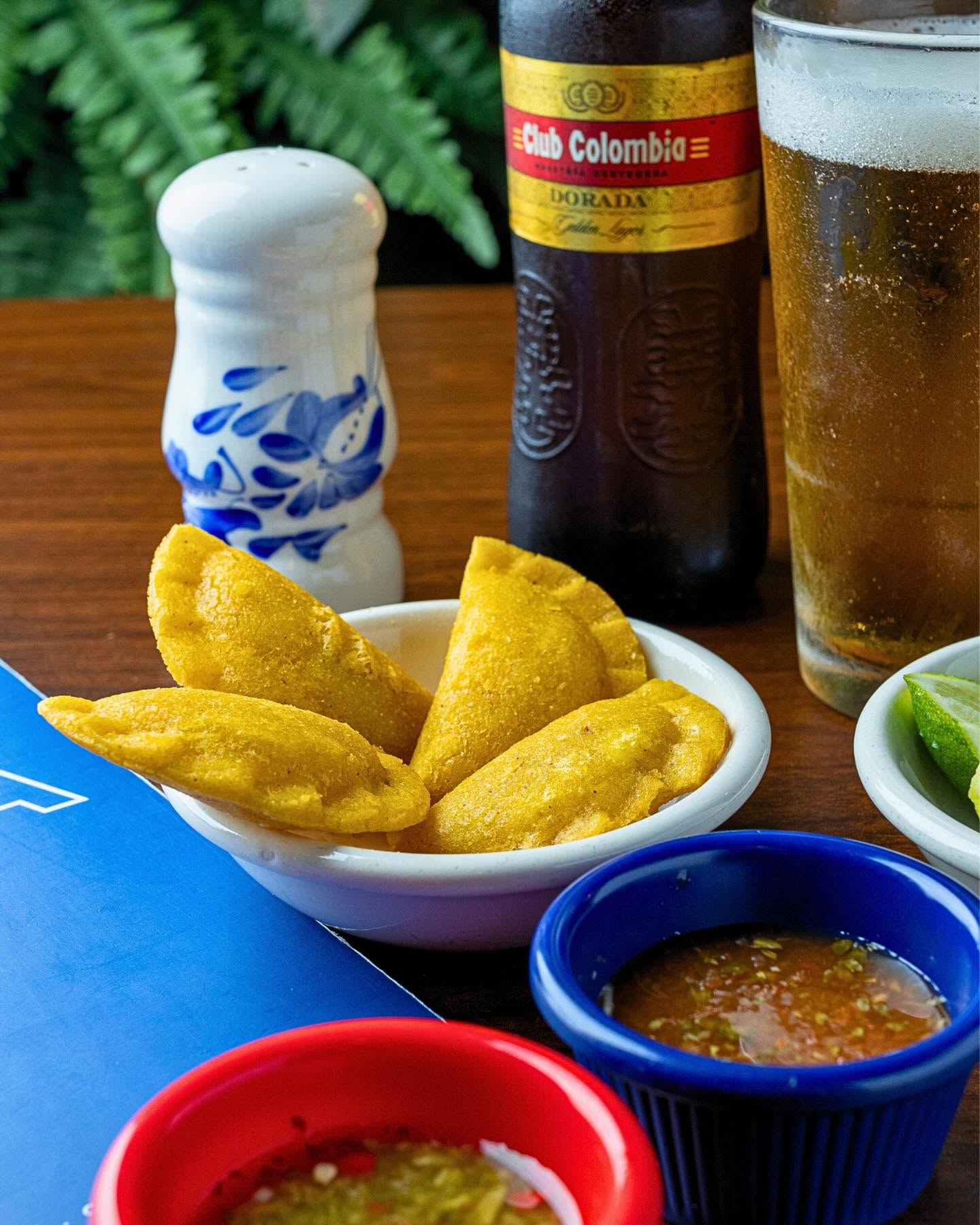Colombian corn empanadas with ají and a cold Club Colombia beer