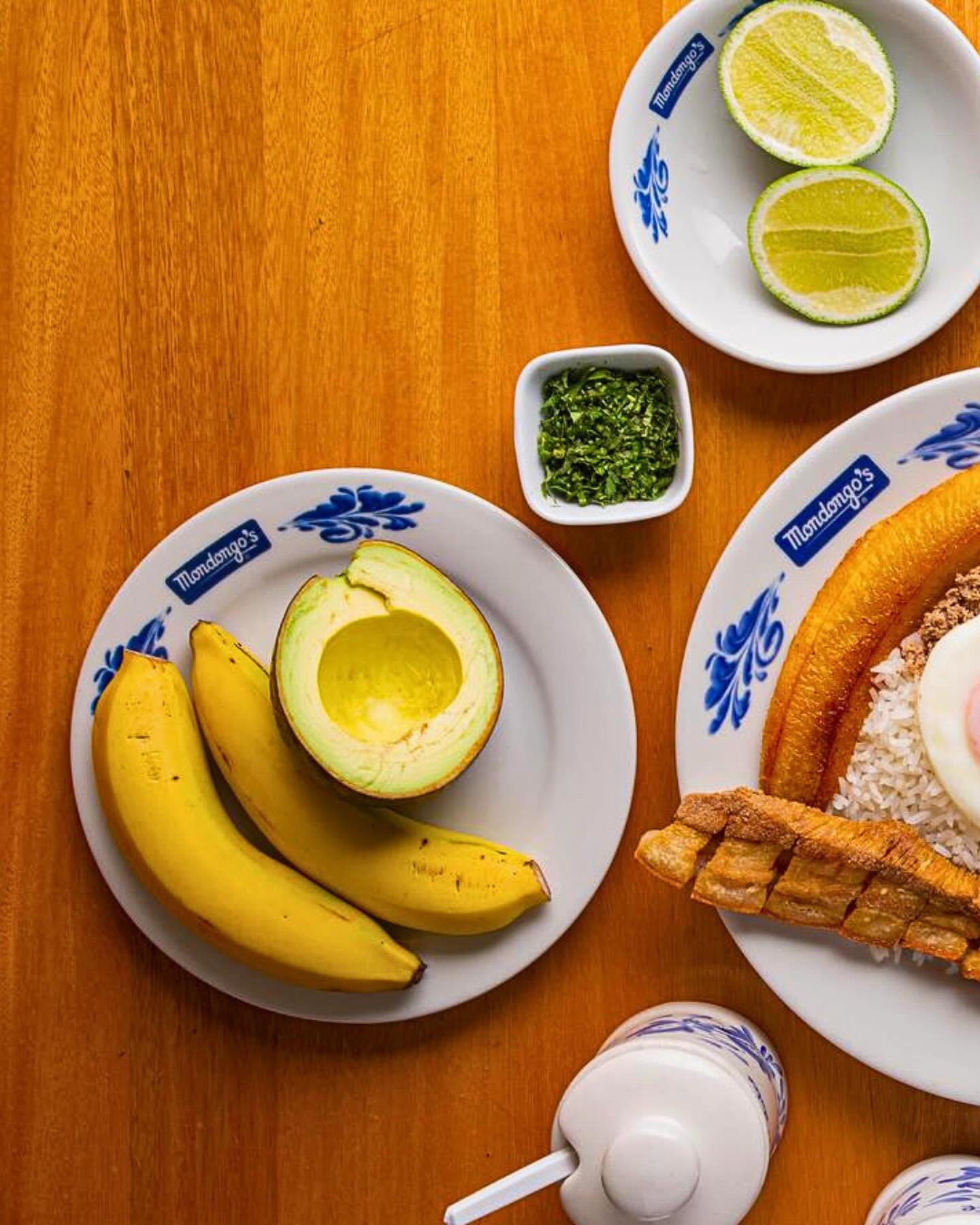 Side plate of avocado and ripe bananas with lime and cilantro