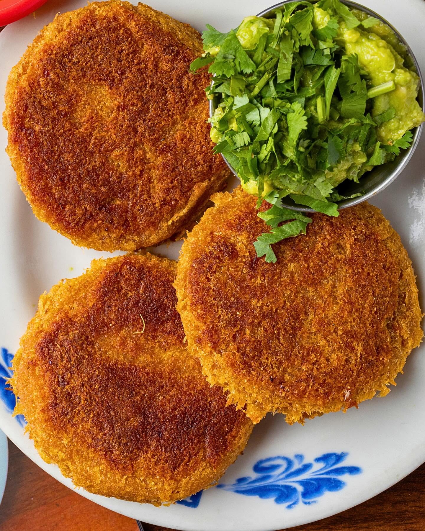 Overhead view of crispy carimañolas with fresh guacamole
