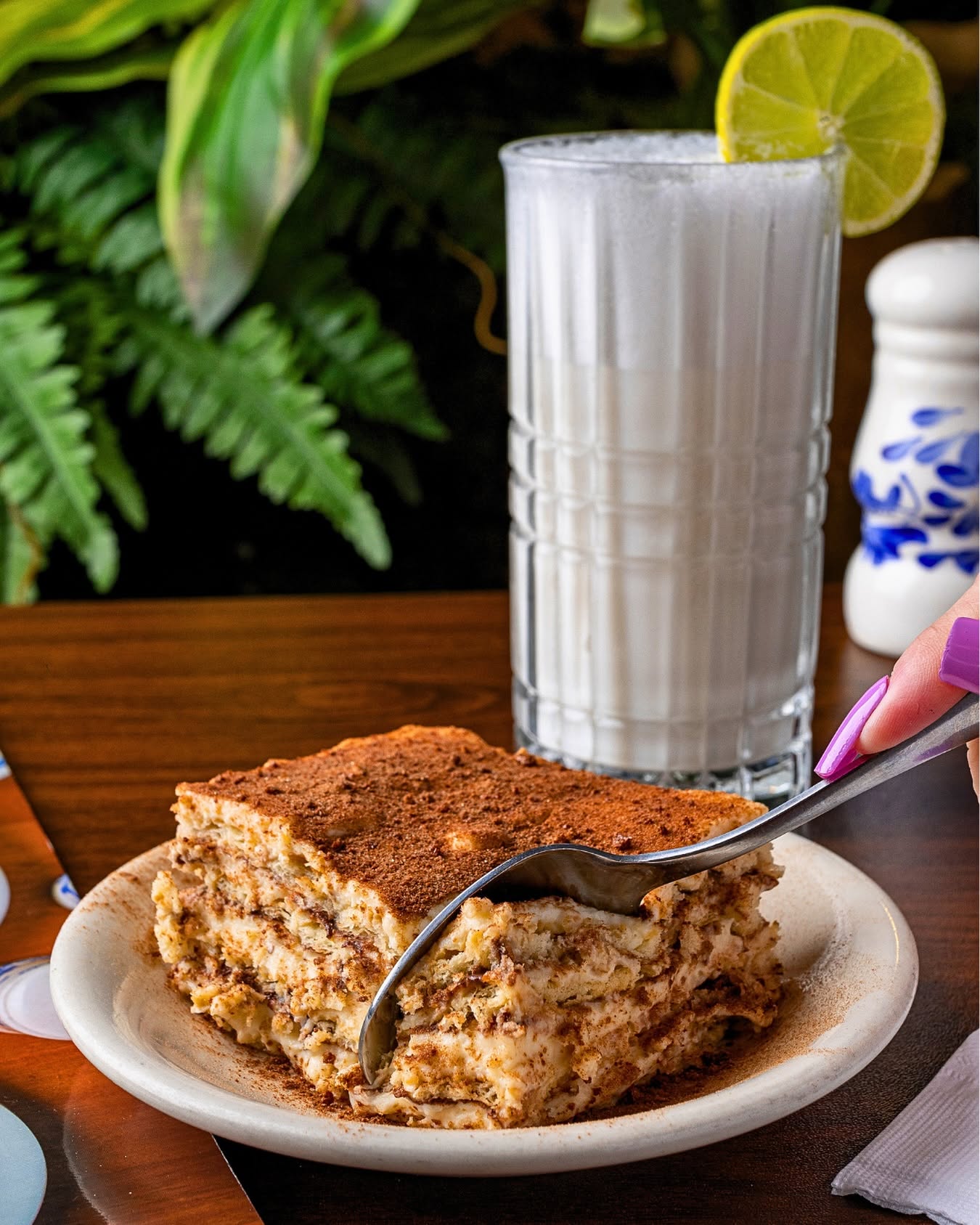 Tiramisu-style layered dessert with a tall glass of horchata