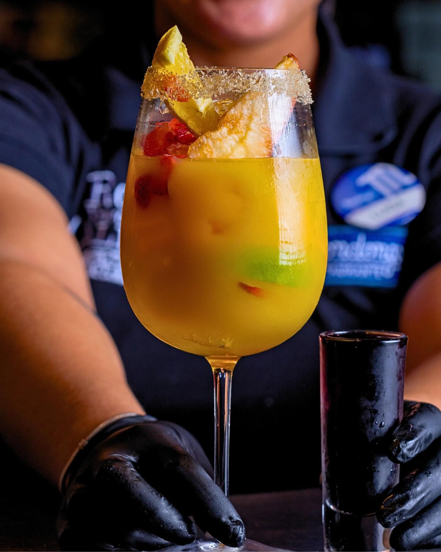 Tropical sangria cocktail with fresh fruit and a sugared rim